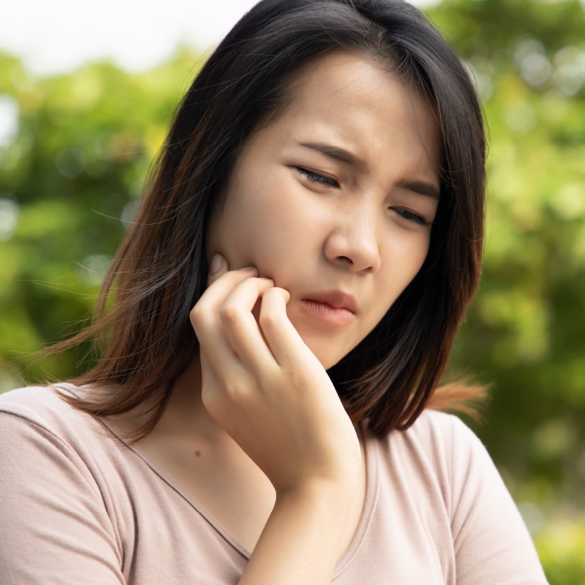 A woman experiencing toothache | Kokua Smiles